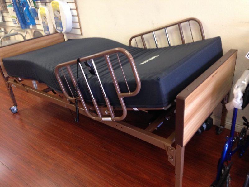 Hospital bed with mattress and rails